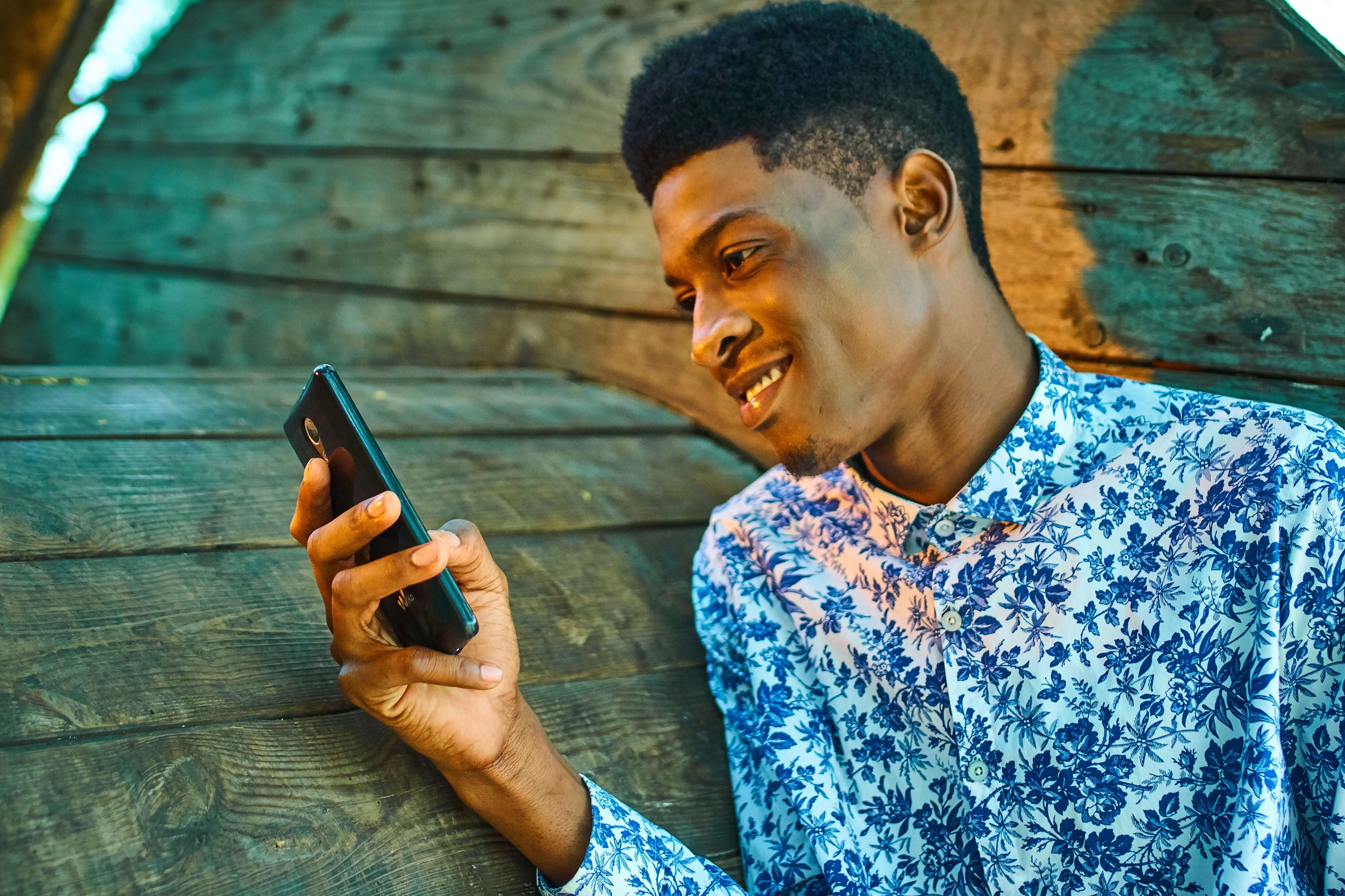 Young-person-uses-phone-for-text-to-donate